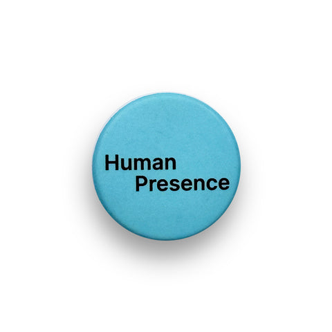 A round blue badge with the words 'Human Presence' in bold black text.