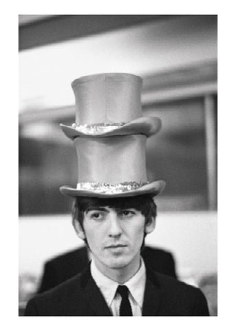 Black and white photographic postcard of George Harrison wearing two hats, taken by Paul McCartney.