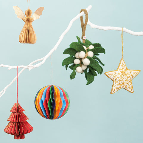 Colourful Christmas decorations on a white branch. 