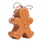 Light brown gingerbread man candle side view.