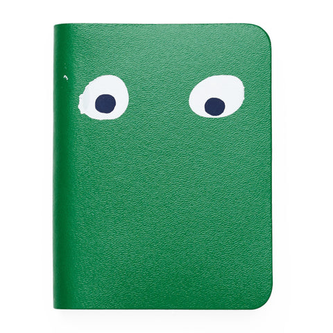 Green mini notebook featuring printed googly eye design . 