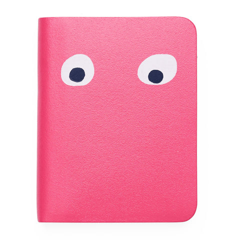 Pink mini notebook featuring printed googly eye design . 