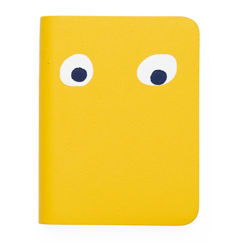 Yellow mini notebook featuring printed googly eye design . 