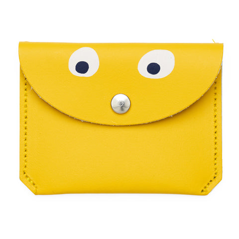 Mini Yellow purse with popper close featuring a printed googly eye design.