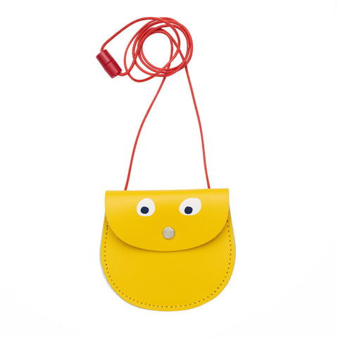 Yellow pocket purse with red strap featuring printed googly eye design . 