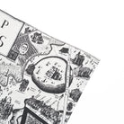 Close up detail of tea towel with black and white map illustration against a white background.
