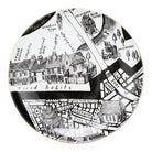 Decorative plate with black and white map design and gold rim on a white background