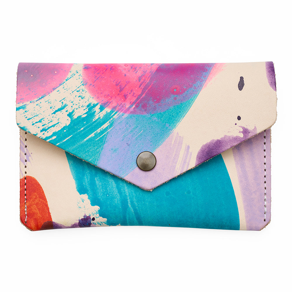 Colorful abstract patterned wallet with a button closure on a white background
