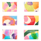 Set of six colorful wallets with abstract designs and gold Ark branding on a white background