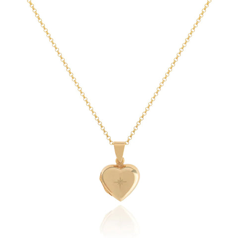 Gold heart shaped locket with engraved star on a gold chain necklace.