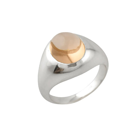 A silver chunky ring with a champagne coloured glass stone in the centre.