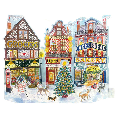 A snowy high street paper advent calendar with three colourful shops.