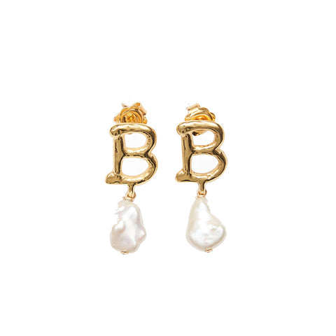 A pair of earrings featuring a gold letter 'B' and large pearl hanging below on each.