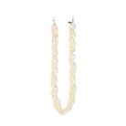 Acetate chain in beige with end loops against a white background.