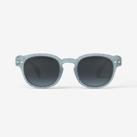 A pair of children's sunglasses with a light blue frame.