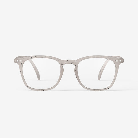 A pair of reading glasses with a light beige speckled frame.