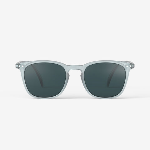 A pair of sunglasses with a light blue frame.
