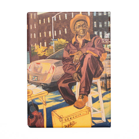 A rectangular magnet featuring a man in a hat sat with an amplifier against a city backdrop.