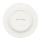 A white ceramic plate shown from the back, featuring a circular raised rim and the name 'Joe Sweeney' written in black ink at the center.