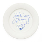 A white ceramic plate with blue cursive writing that reads 'You & I are Queen 2026' shown on a plain white background.