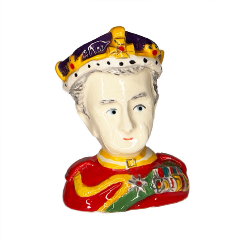 King Charles III ceramic egg cup bust with red uniform and crown, front view.