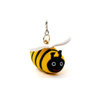 Knitted bee keychain with black and yellow stripes on a white background