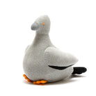 Grey knitted pigeon rattle toy against a white background