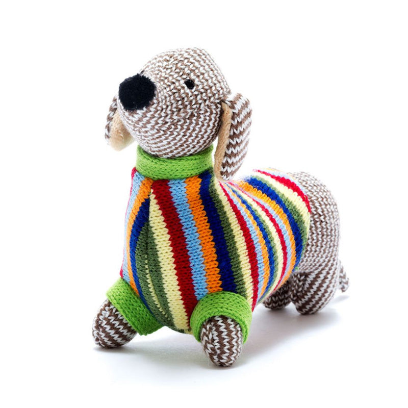 Knitted brown dachshund rattle in a colourful striped jumper.