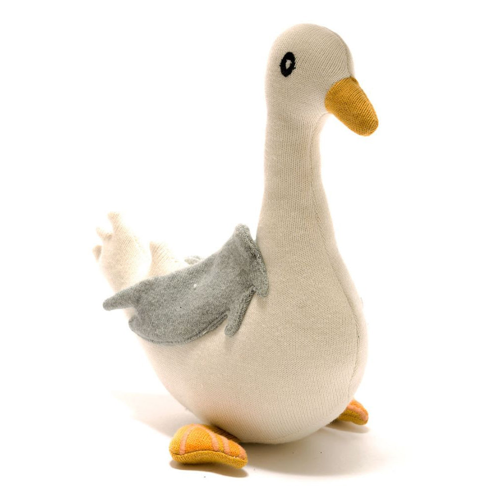 Plush toy seagull with a white body, grey wings, and orange beak on a white background