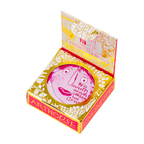 Pink lip balm case in gold and red detailed packaging. 