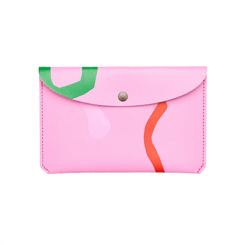 Pink rectangular purse with folded close and popper featuring a paint splatter abstract pattern.