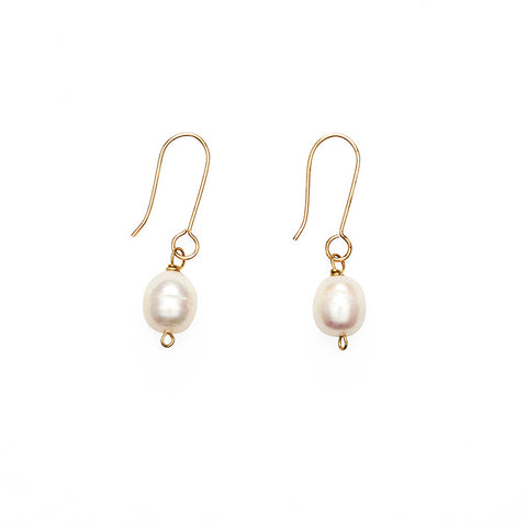 A pair of earrings featuring a single pearl hanging from a gold hook.