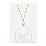 Large single pearl pendant handing from a gold chain necklace attached to NPG packaging.