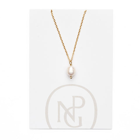 Large single pearl pendant handing from a gold chain necklace attached to NPG packaging.