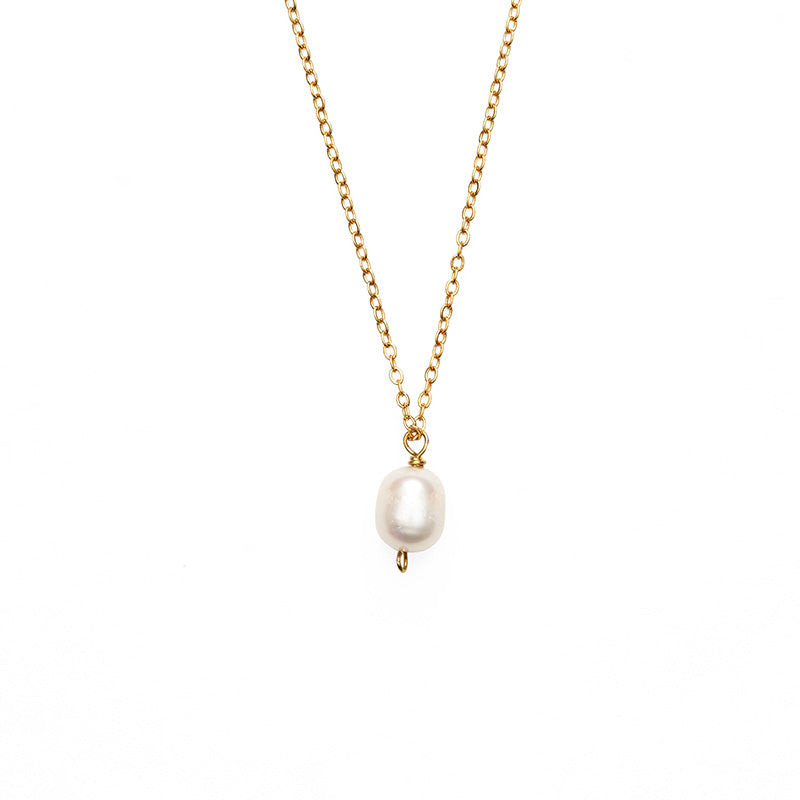 Large single pearl pendant hanging from a gold chain necklace. 