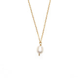 Large single pearl pendant hanging from a gold chain necklace. 