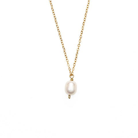 Large single pearl pendant hanging from a gold chain necklace. 