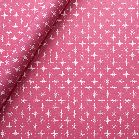 Bright pink wrapping paper with small white stars on it. 