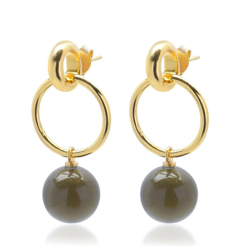 A pair of gold earrings each with a gold loop from which a small glass smoky grey ball hangs.