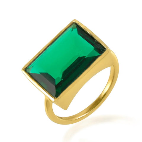 A gold band ring with a rectangular green crystal in the centre.