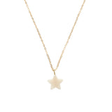 A gold chain necklace with a small white star pendant.