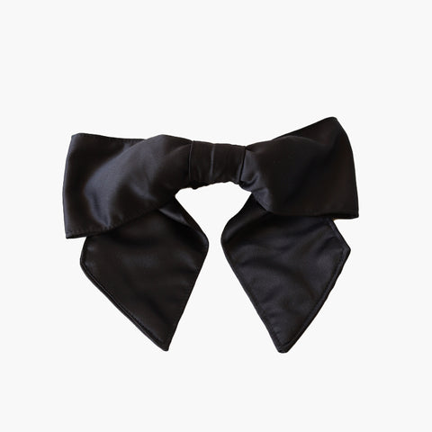 A scrunchie hair accessory featuring a bow made from black satin
