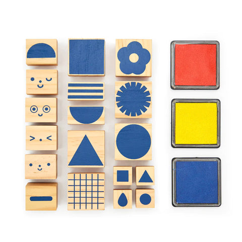 A set of wooden ink stamps with geometric shapes, flowers and faces.