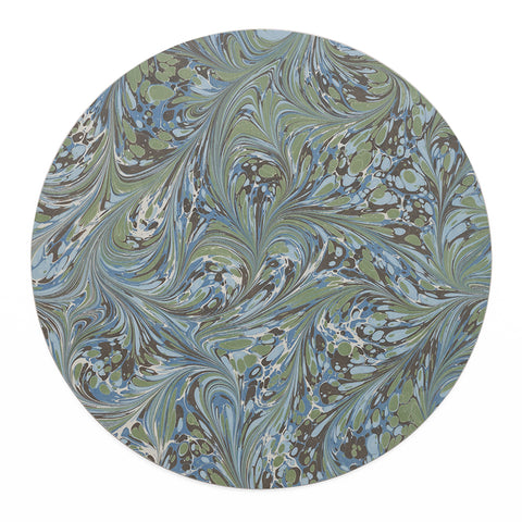 A round table mat in marbled green and blue pattern.