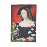 Tea towel of a dark haired woman in a red room with a blue dress on, holding a green bird.