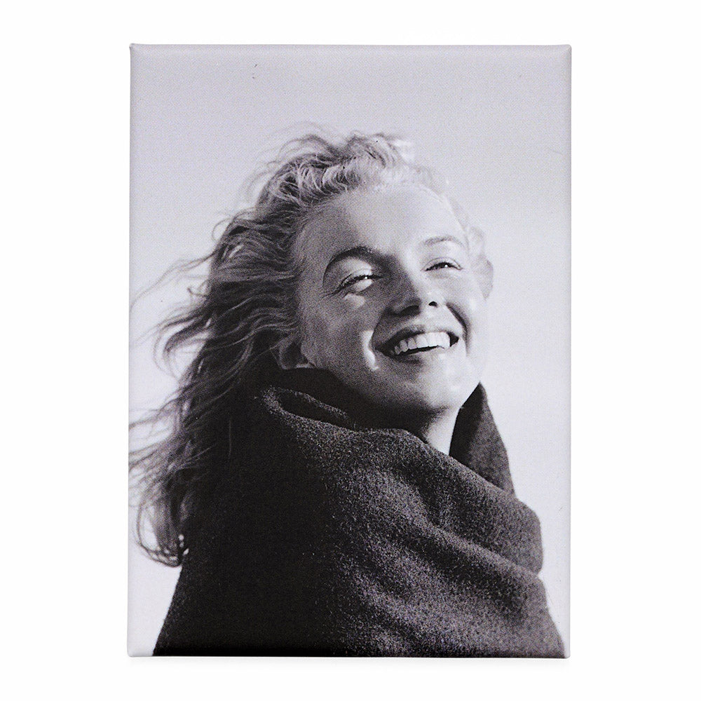 A magnet with a black and white photograph of a woman smiling against a white background.