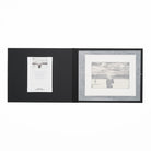 Open black folio with certificate of authenticity and a black and white photo print.