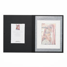 Close up view of an open folio with a print and certificate of authenticity.