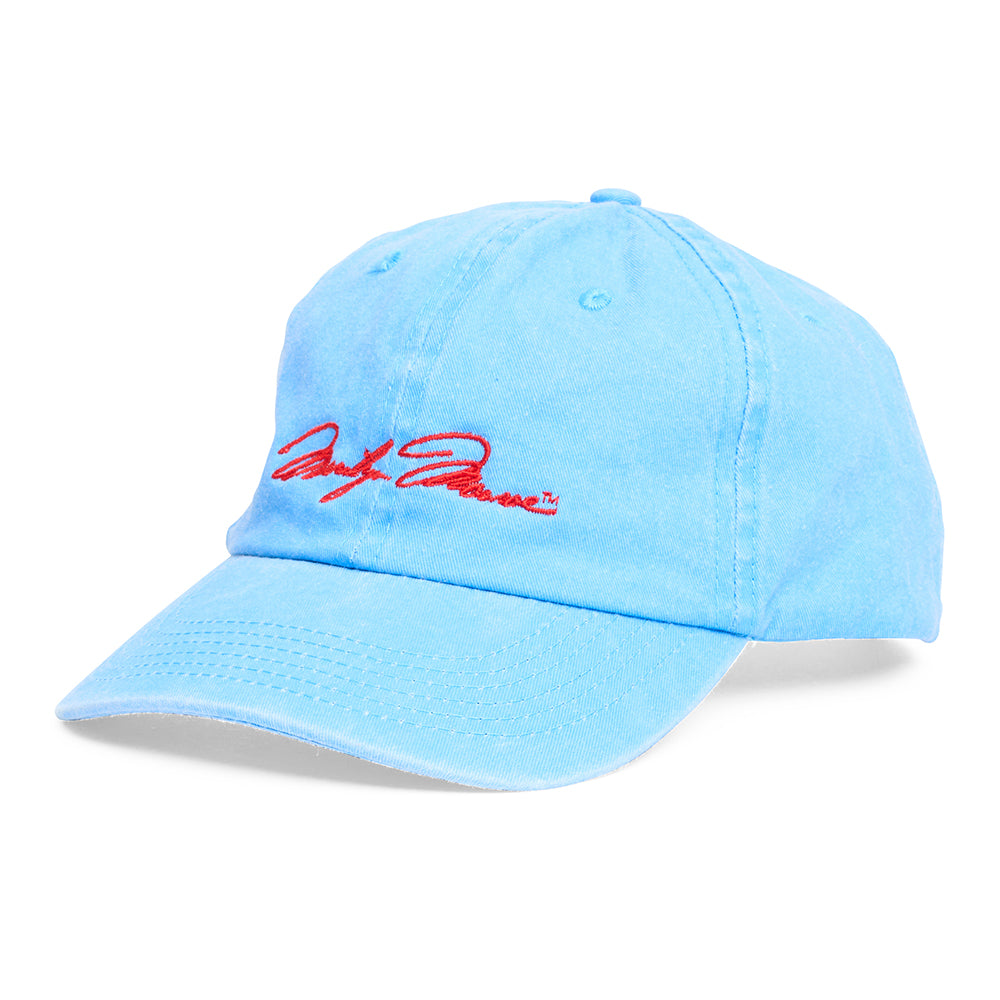 Side view of blue cap with red embroidered signature on a white background