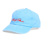 Side view of blue cap with red embroidered signature on a white background